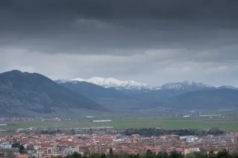 Widok na miasto Korce w Albanii z ośnieżonymi górami w tle.