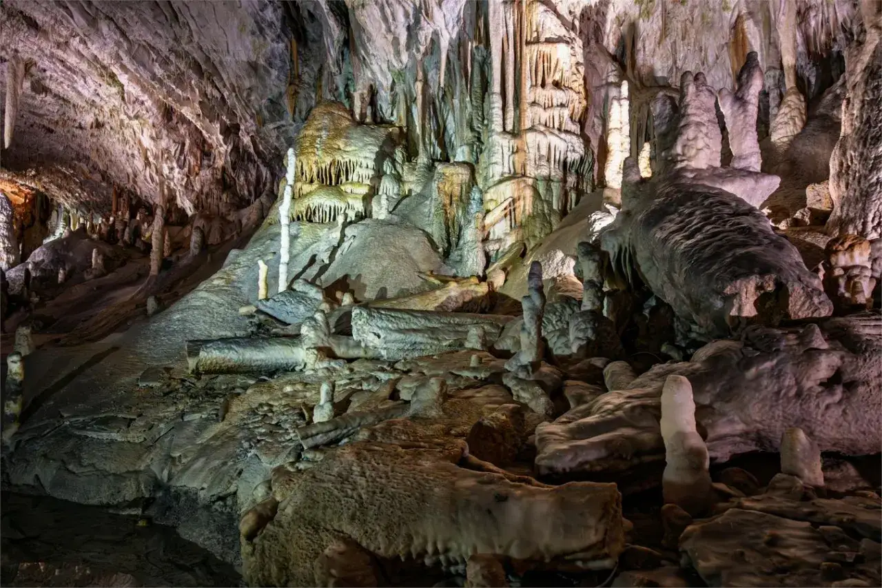 Wnętrze jaskini Postojna, pełne stalaktytów i stalagmitów, tworzy niezwykły, podziemny krajobraz.